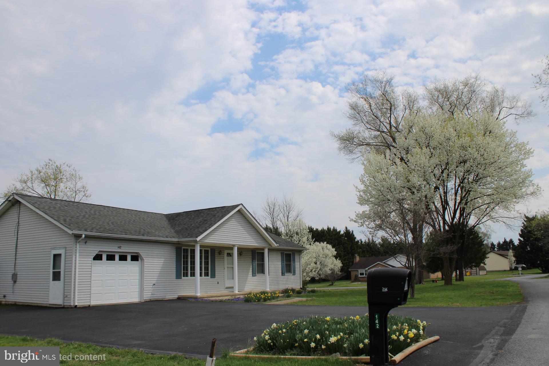 142 Braddock Boulevard Inwood, WV 25428 - Photo 2 of 36 a front view of a house with a yard