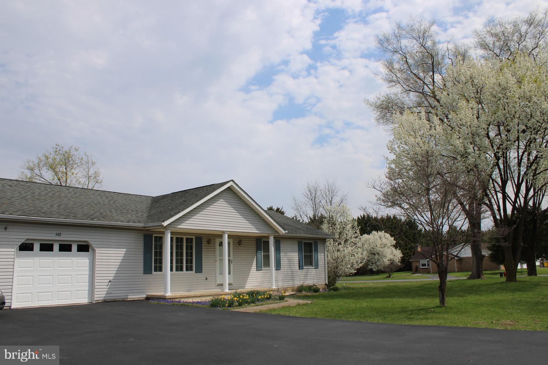 142 Braddock Boulevard Inwood, WV 25428 - Photo 3 of 36 a front view of a house with a garden
