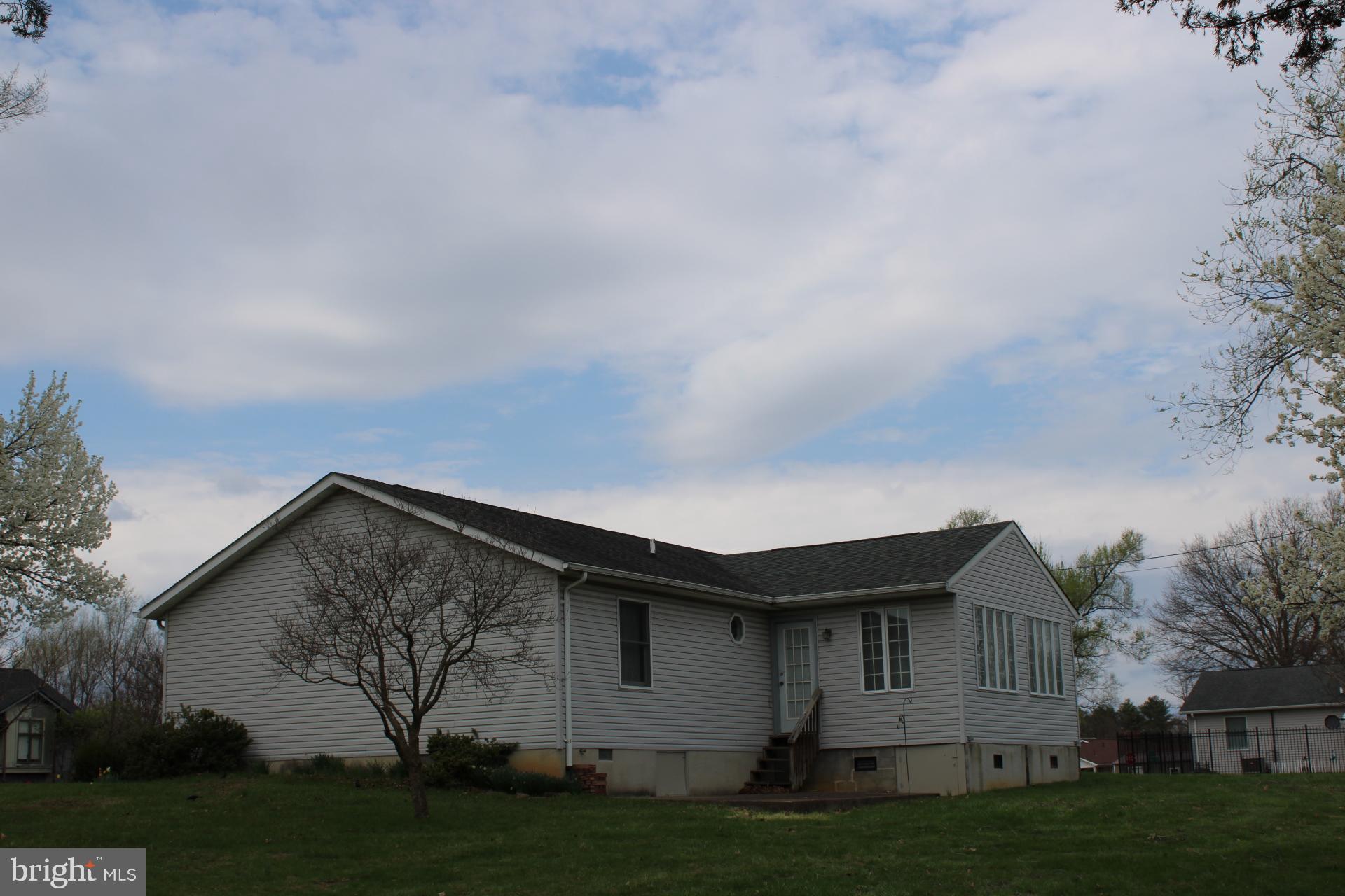 142 Braddock Boulevard Inwood, WV 25428 - Photo 33 of 36 a backyard of a house with plants and trees