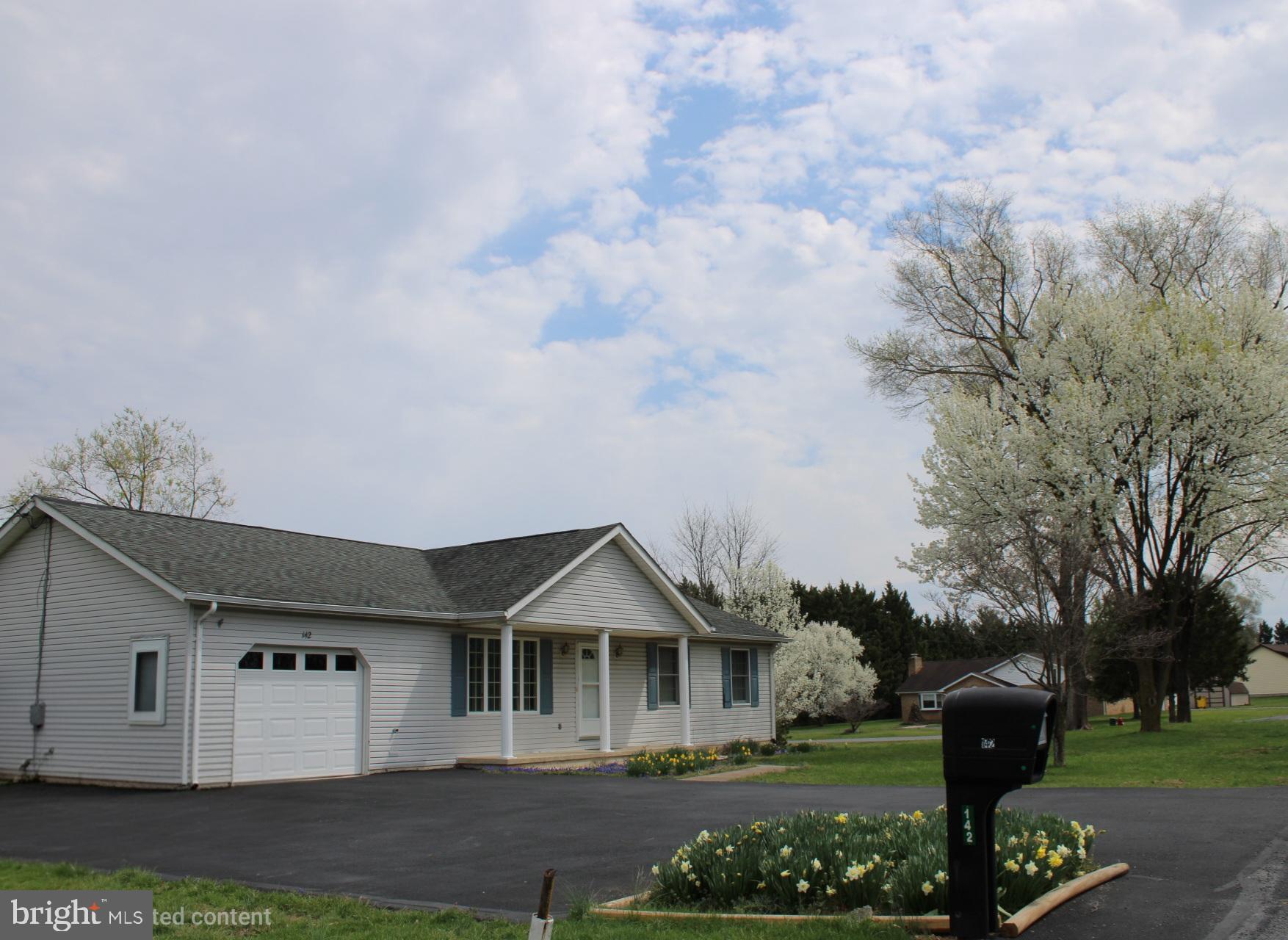 142 Braddock Boulevard Inwood, WV 25428 - Photo 7 of 36 a front view of a house with garden