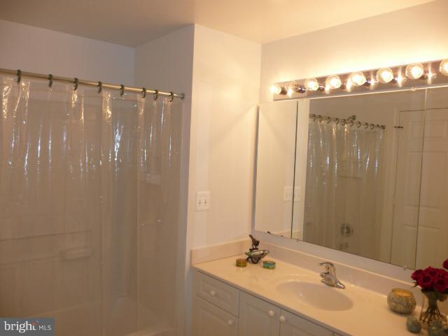 19355 Cypress Ridge Terrace, Unit 807 Leesburg, VA 20176 - Photo 3 of 29 a bathroom with a sink and a mirror