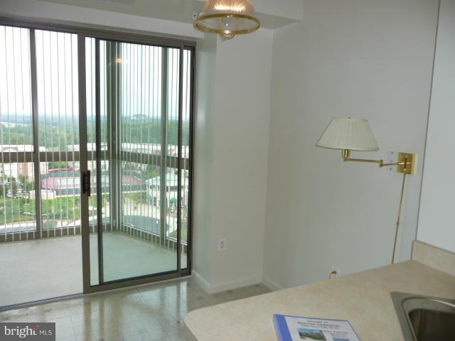 19355 Cypress Ridge Terrace, Unit 807 Leesburg, VA 20176 - Photo 10 of 29 a room with a bed and a chandelier