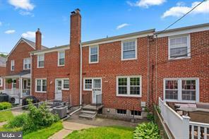 a front view of a house with swimming pool and glass windows