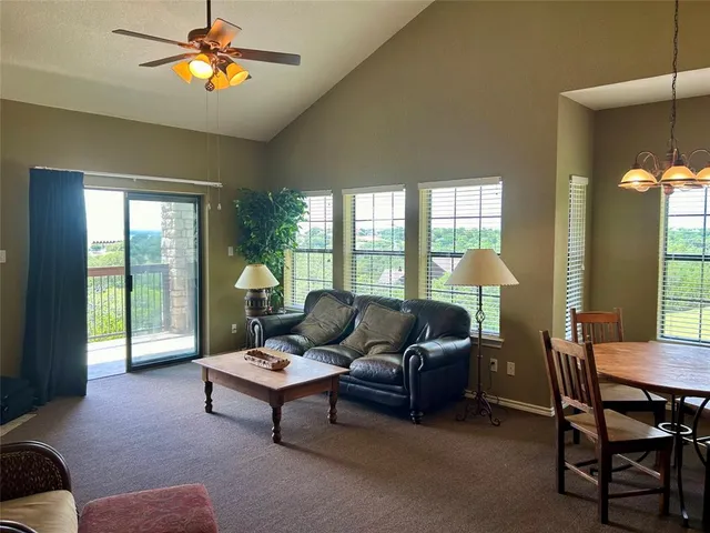 a living room with furniture and a floor to ceiling window