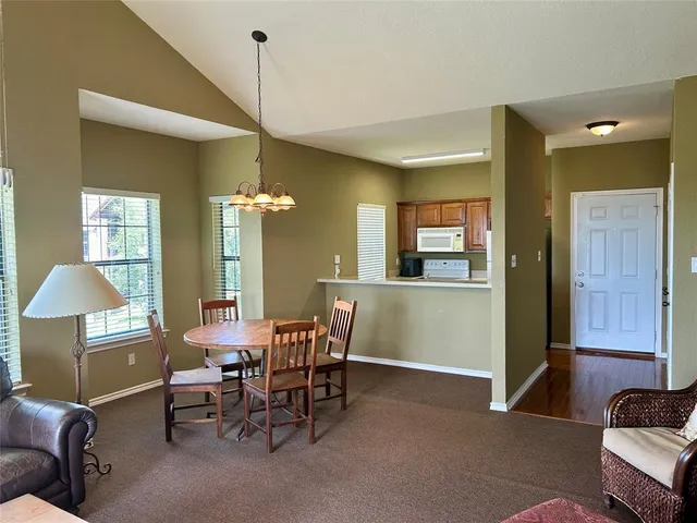 a dining room with furniture and a chandelier