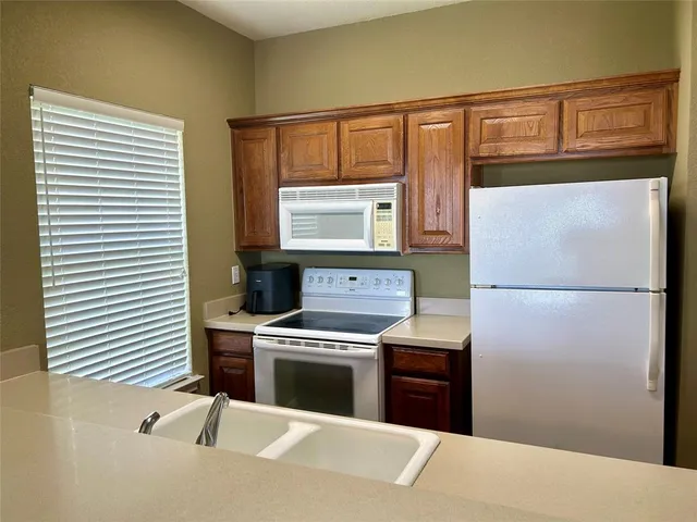 a kitchen with a refrigerator stove and oven