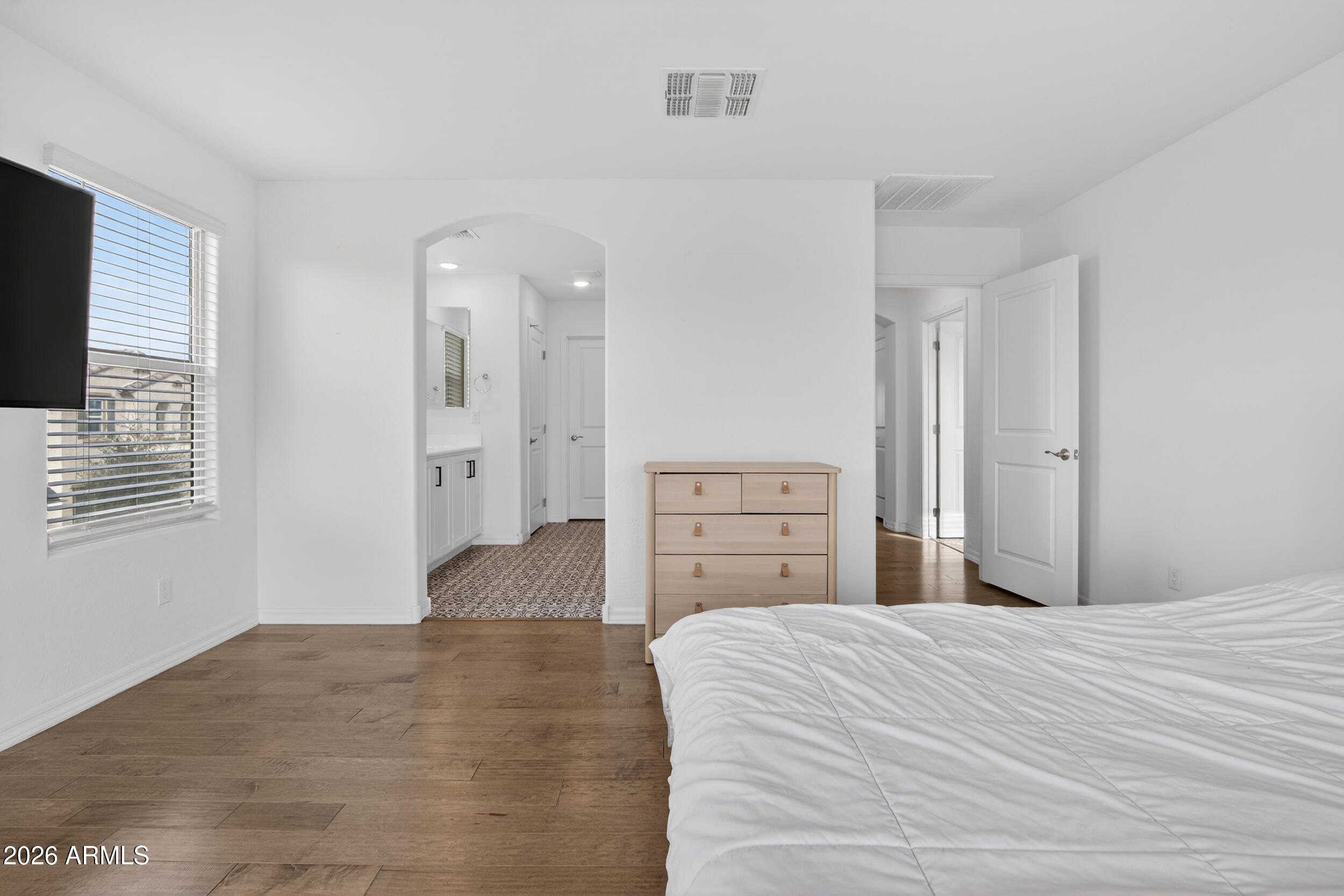 15177 West Desert Bloom Street Goodyear, AZ 85338 - Photo 20 of 55 a bedroom with a bed and a flat screen tv
