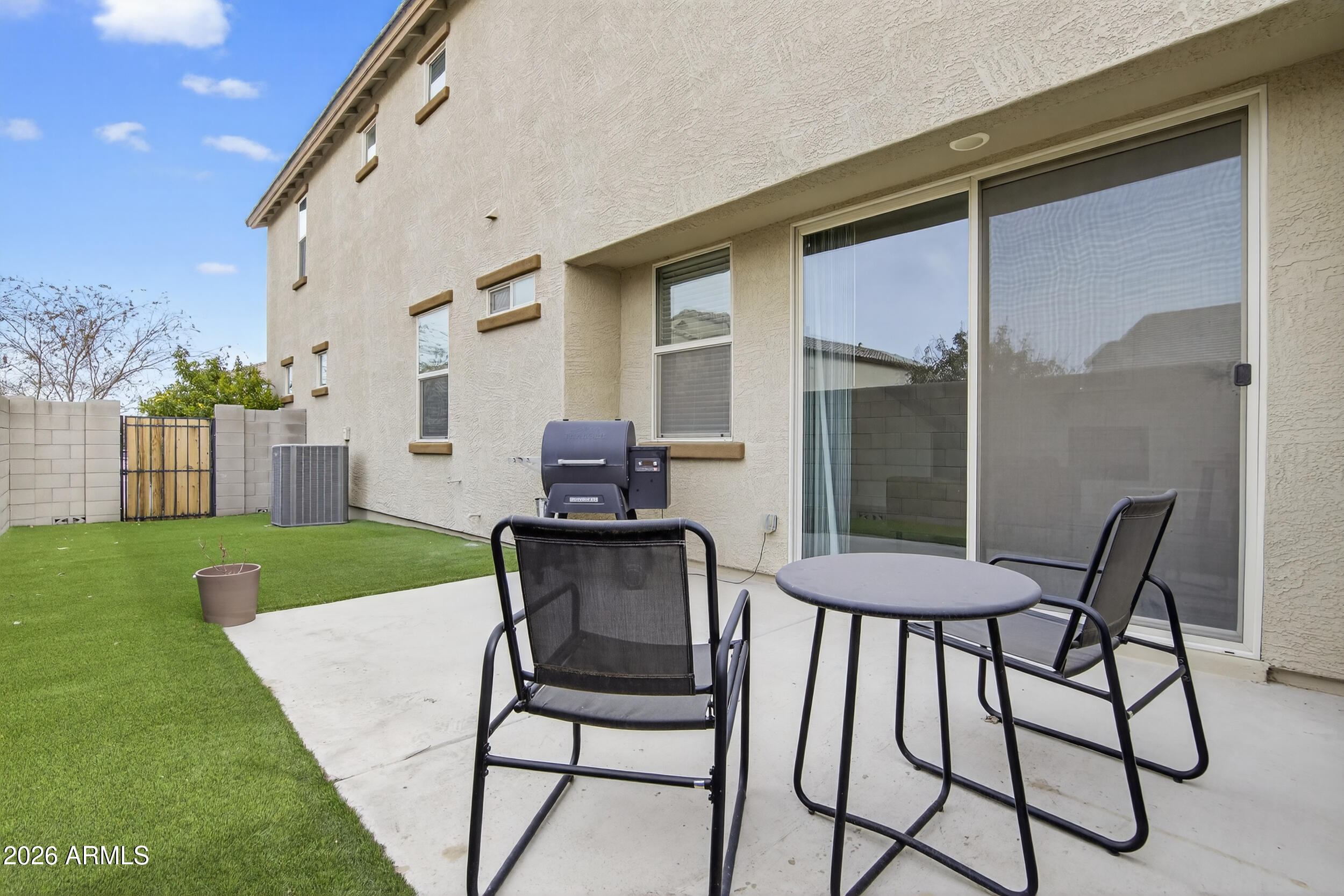 15177 West Desert Bloom Street Goodyear, AZ 85338 - Photo 46 of 55 a table and chairs in front of a house