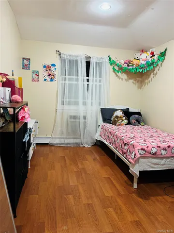 a bedroom with a bed and a flat tv screen