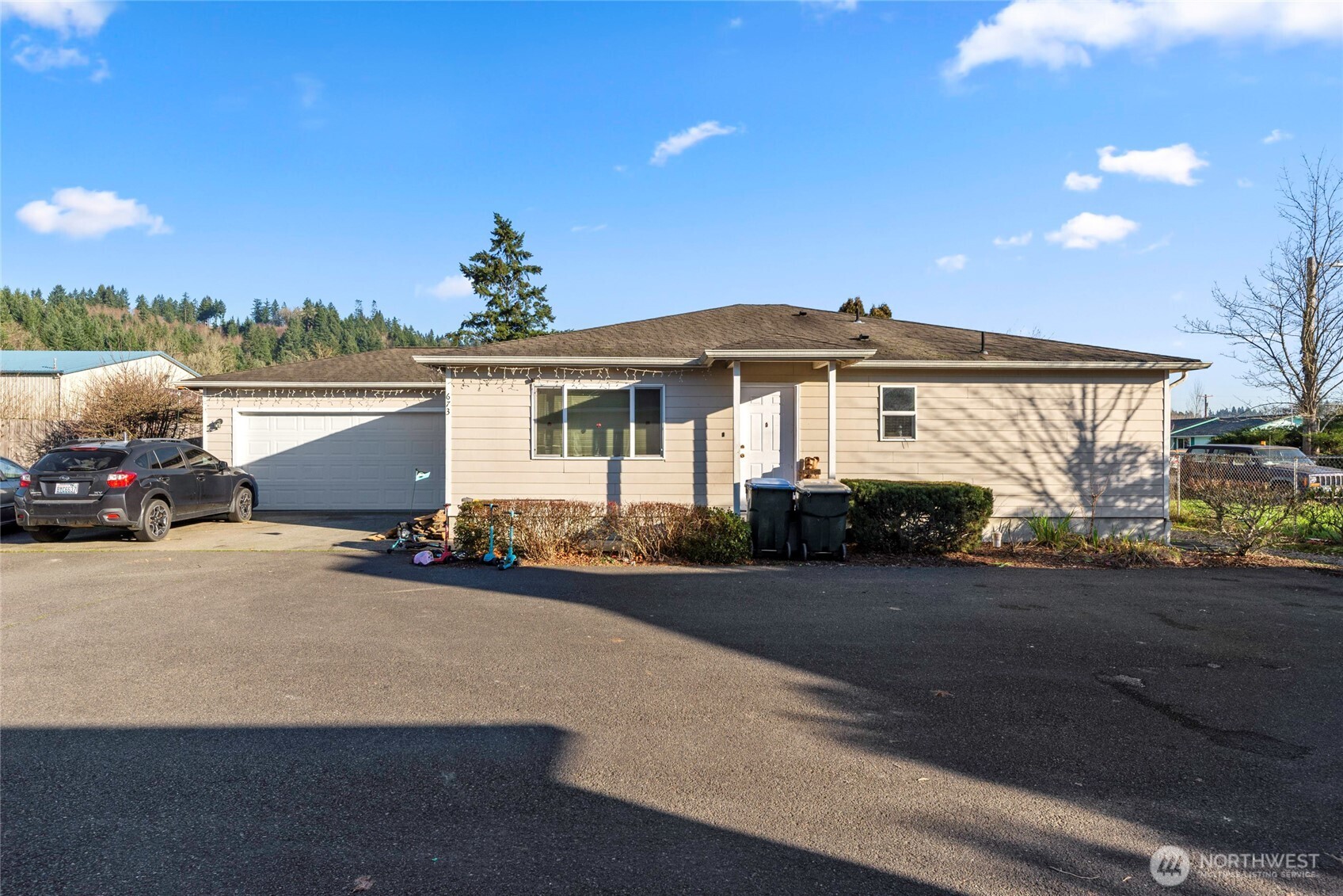 673 Southwest 20th Street Chehalis, WA 98532 - Photo 9 of 17 a front view of a house with a yard and garage