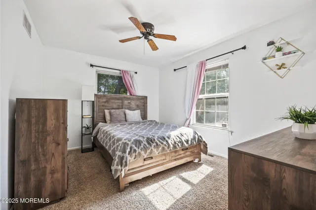 a bedroom with a bed potted plant and a window