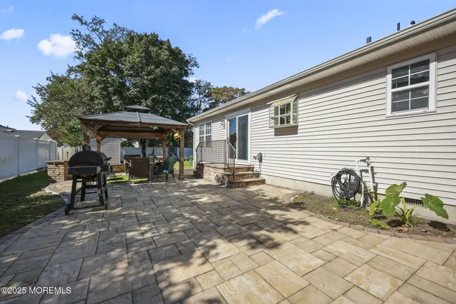 a backyard of a house with table and chairs