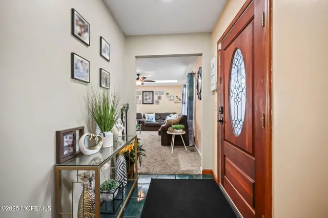 a view of living room filled with furniture and a potted plant
