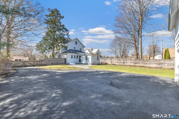 a view of a swimming pool with palm trees in front of it