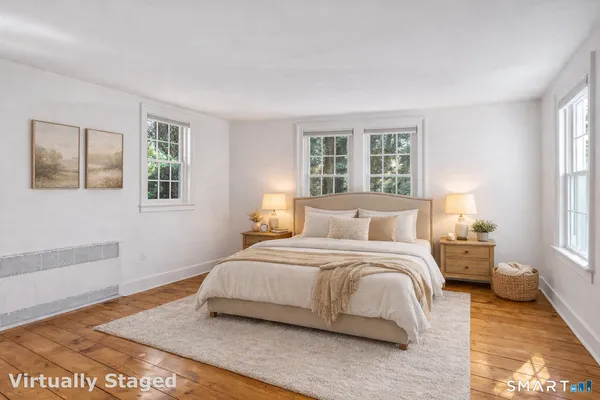 a bedroom with a large bed and a window