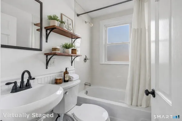 a bathroom with a sink a toilet and bathtub