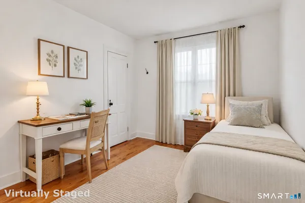 a bedroom with a bed and a table in it