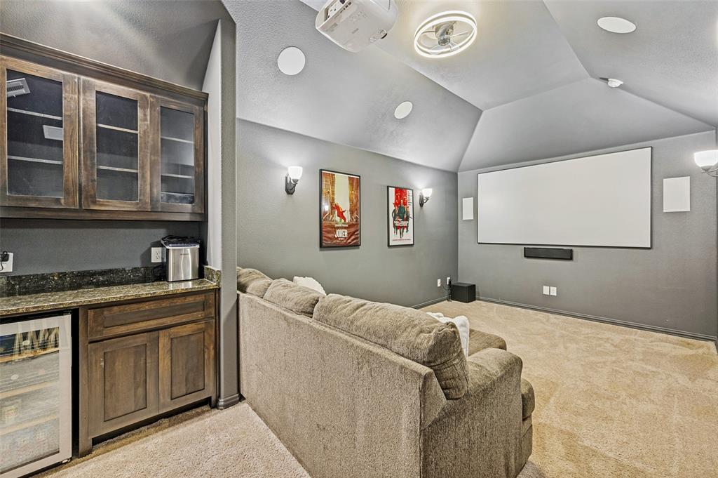 808 Violet Way Celina, TX 75009 - Photo 19 of 30 Vaulted Ceilings in Media room. Featuring 100-inch projector screen, projector, dry bar with beverage fridge, and immersive 7.1 surround sound system for the ultimate movie-night experience.