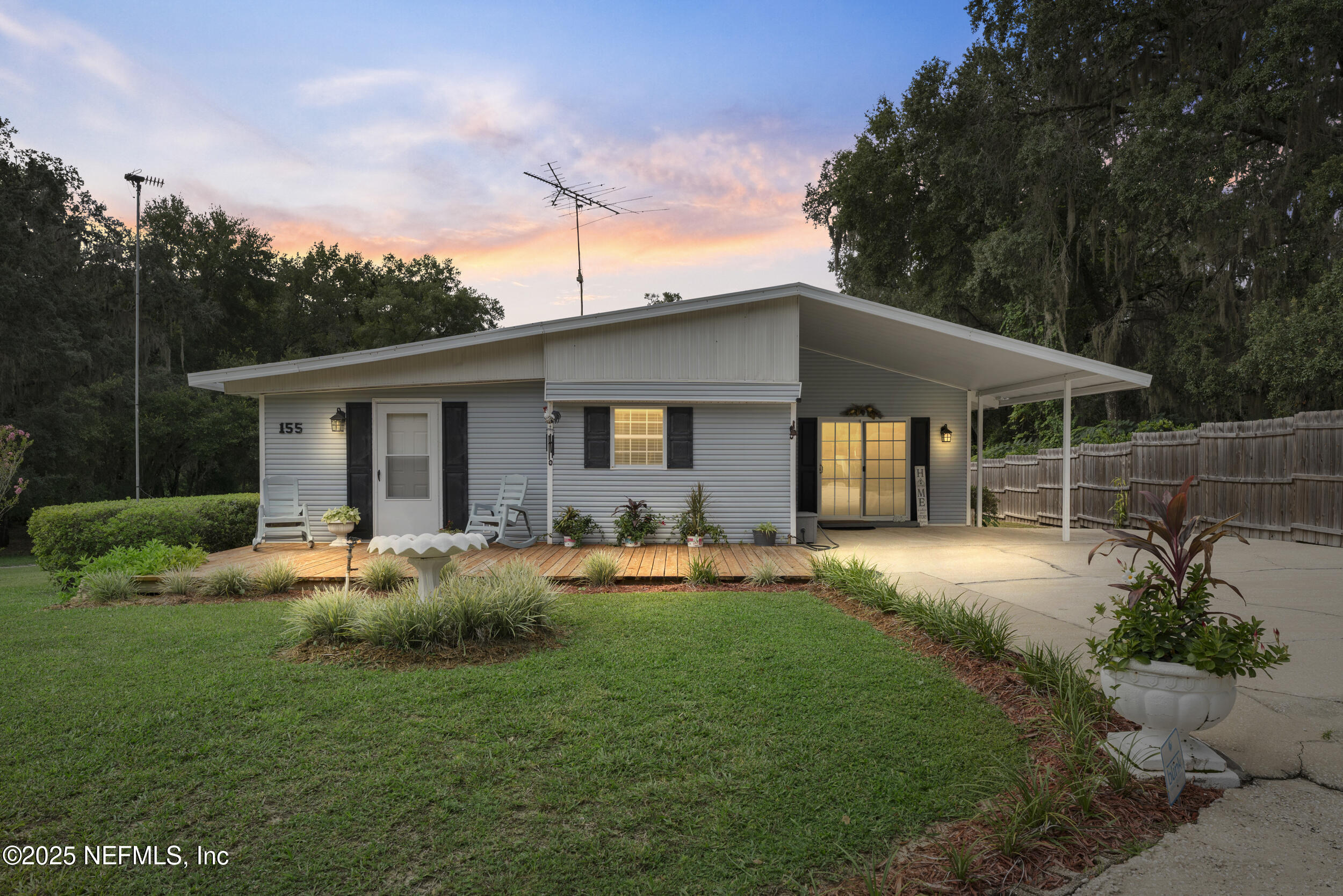 a front view of a house with patio and garden