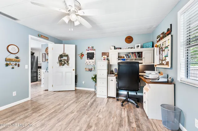 a spacious bedroom with a bed and a chandelier