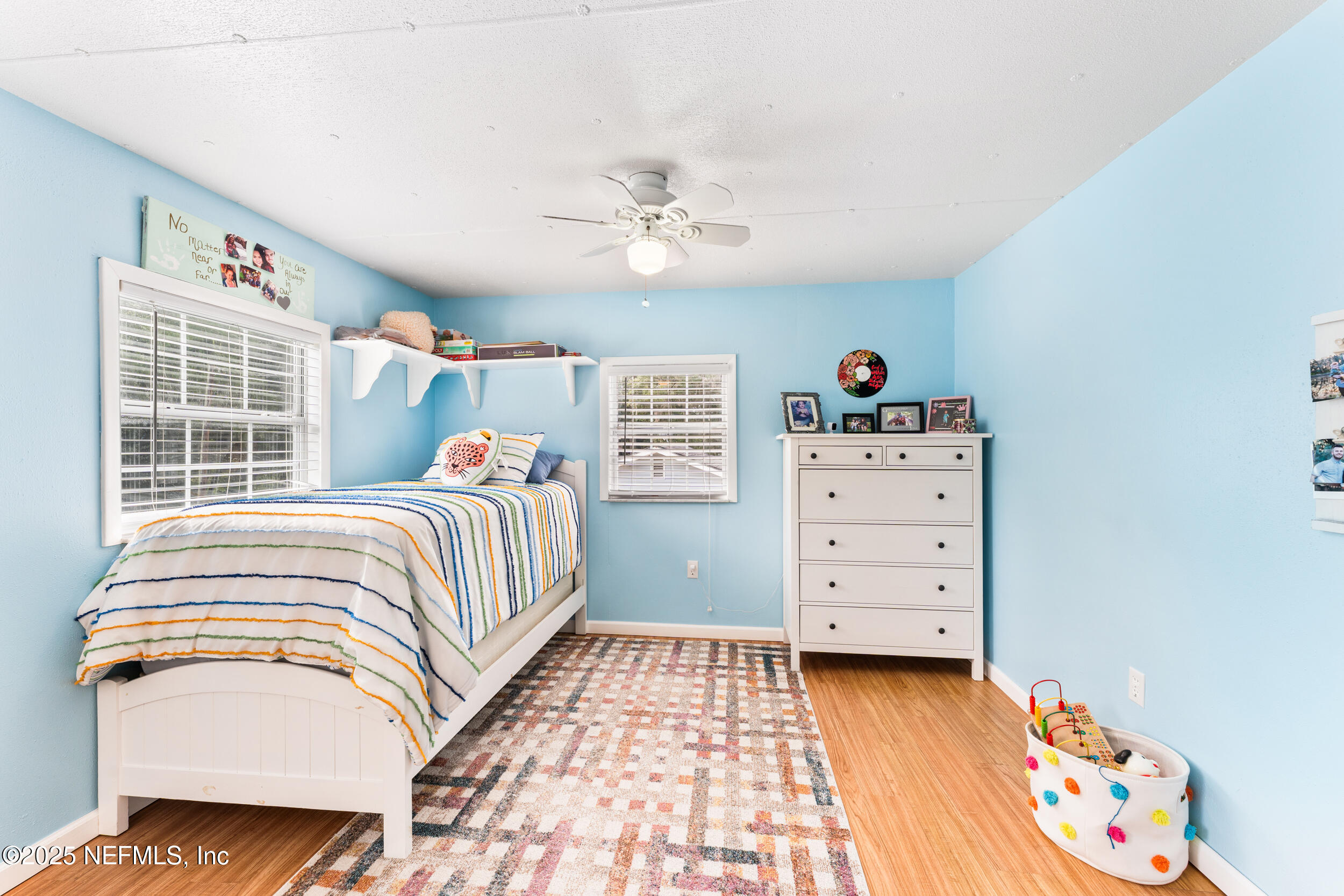 155 Tompkins Road Pomona Park, FL 32181 - Photo 15 of 38 a bedroom with a bed and wooden floor