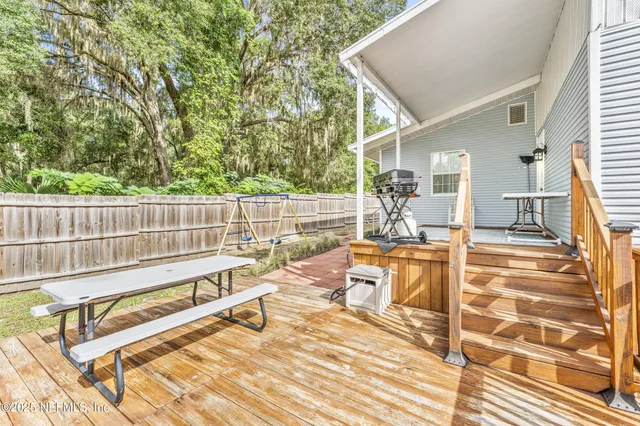a backyard of a house with table and chairs