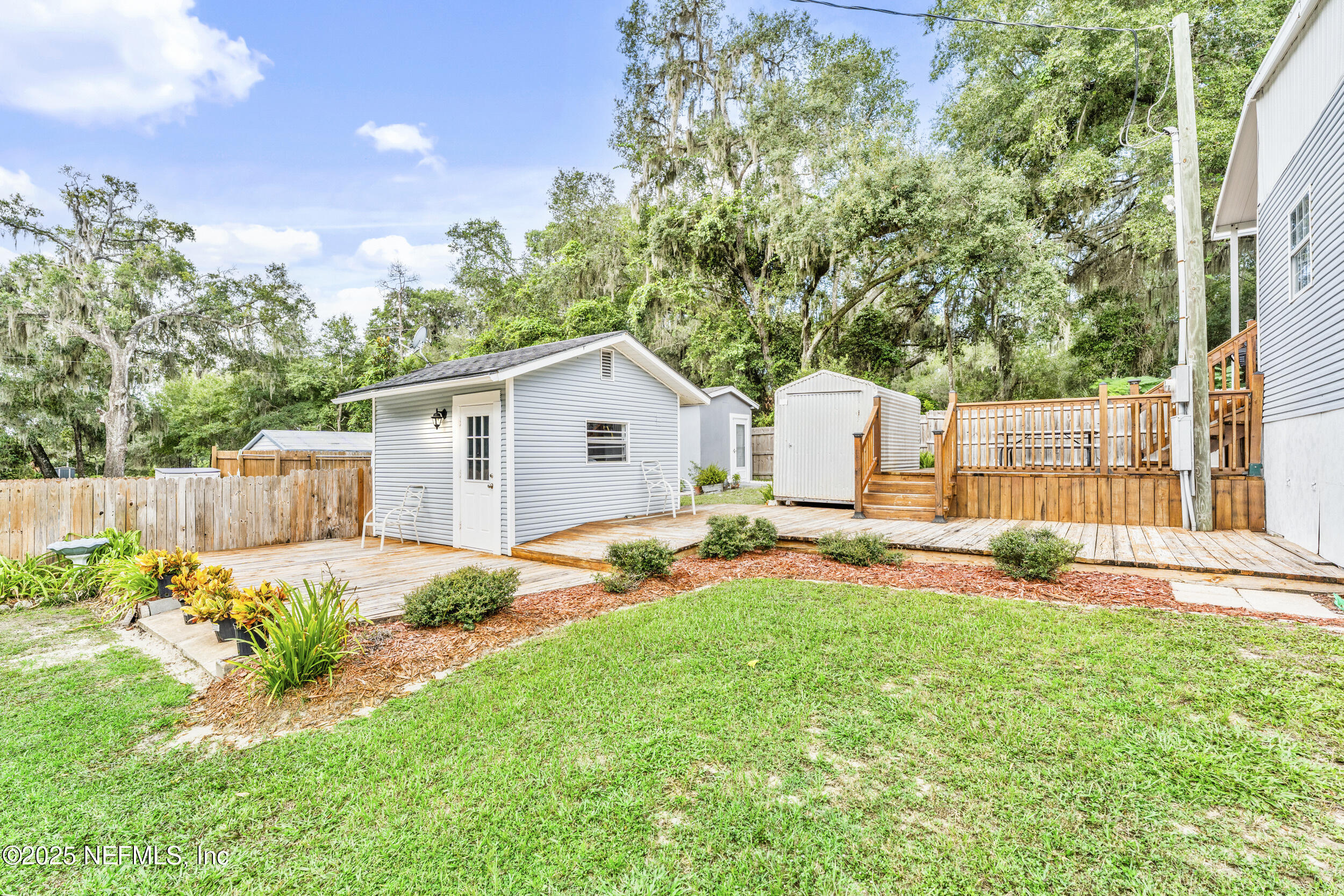 155 Tompkins Road Pomona Park, FL 32181 - Photo 24 of 38 a backyard of a house with table and chairs