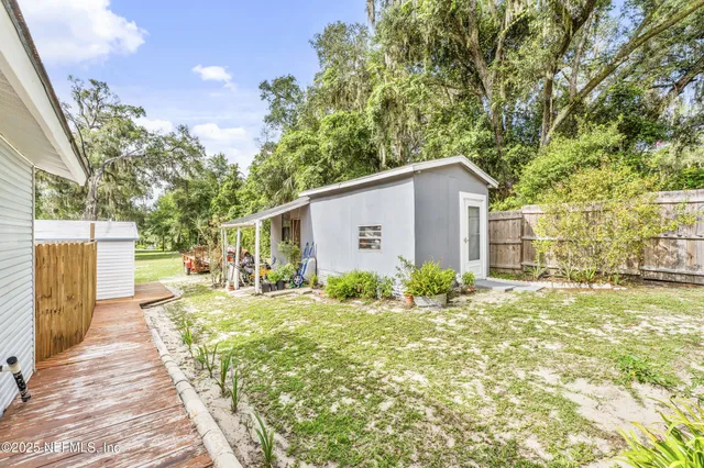 a yard with lots of green space and trees
