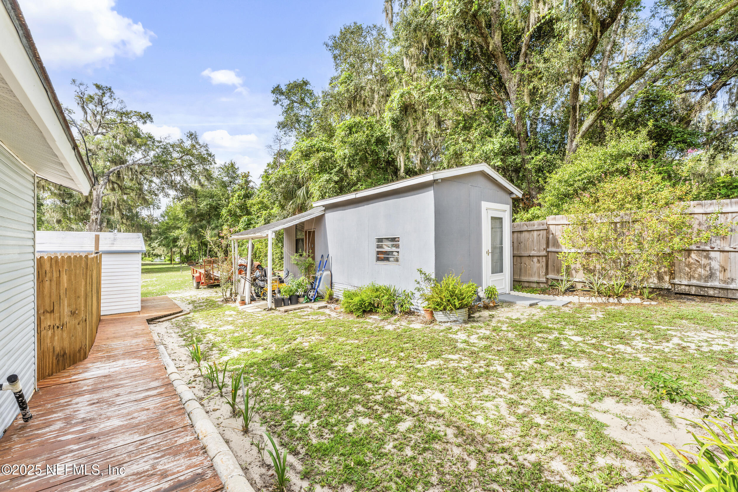 155 Tompkins Road Pomona Park, FL 32181 - Photo 25 of 38 a yellow house with trees in front of it
