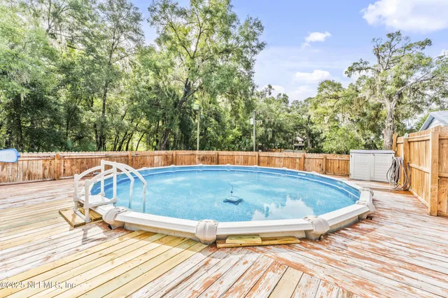 a view of outdoor space with deck and trees