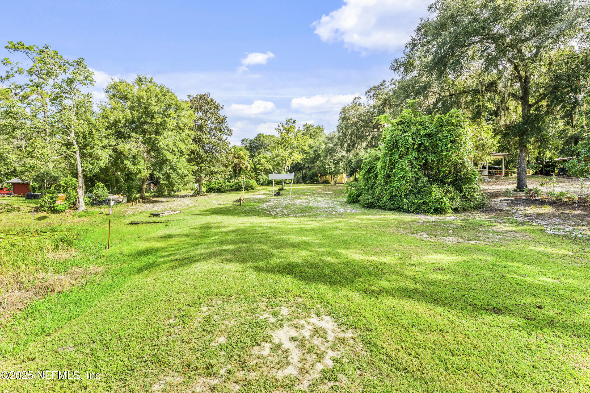 155 Tompkins Road Pomona Park, FL 32181 - Photo 32 of 38 a view of a green field with trees in the background