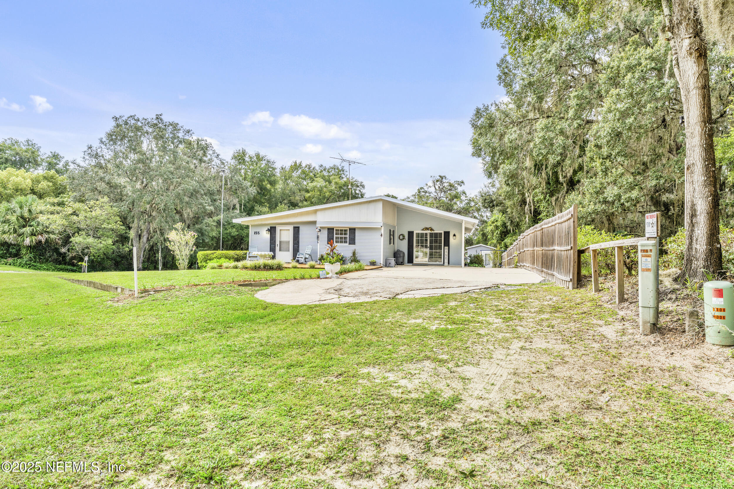 155 Tompkins Road Pomona Park, FL 32181 - Photo 5 of 38 a house with swimming pool in front of it