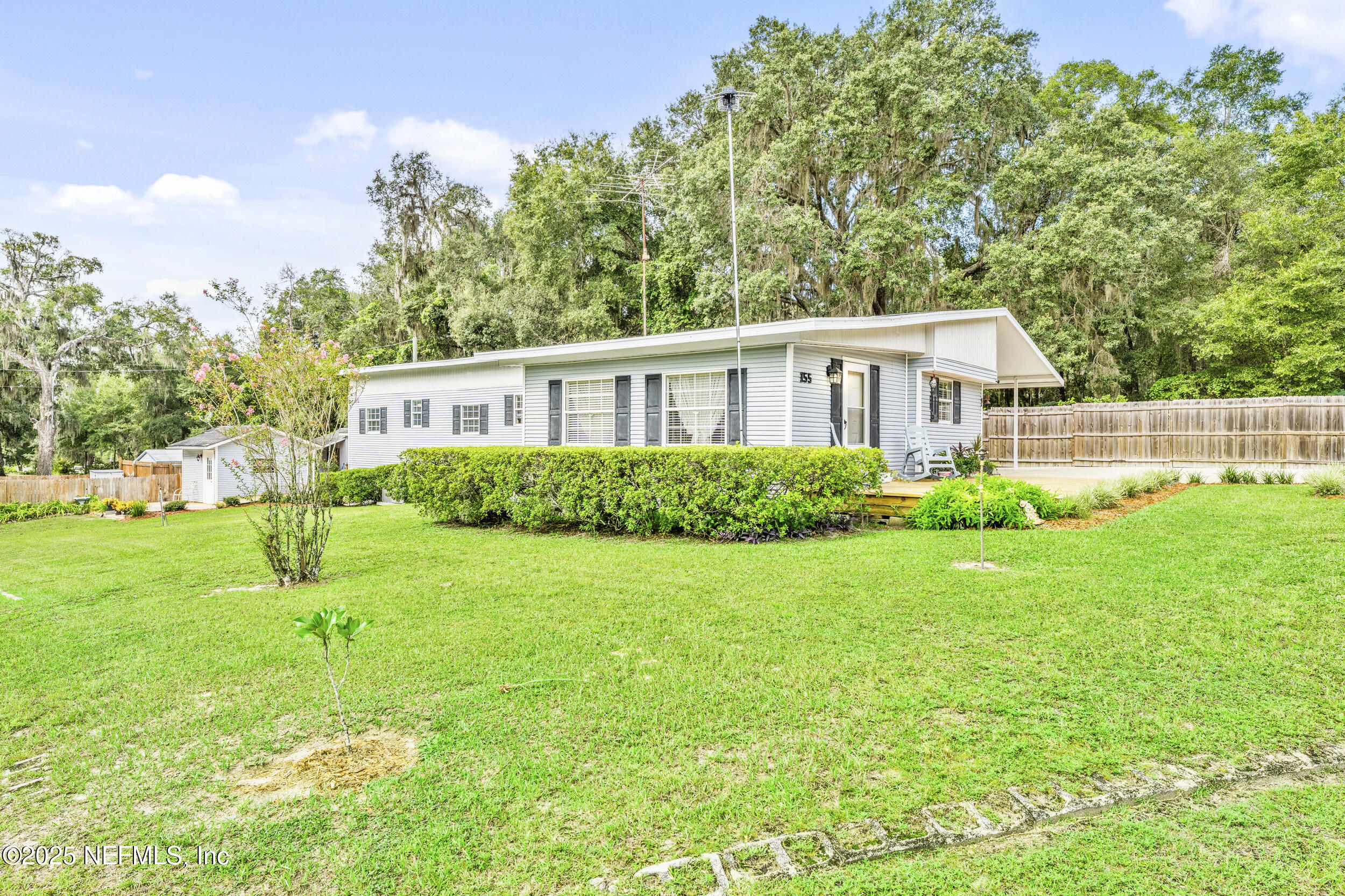 155 Tompkins Road Pomona Park, FL 32181 - Photo 6 of 38 a house view with a garden space