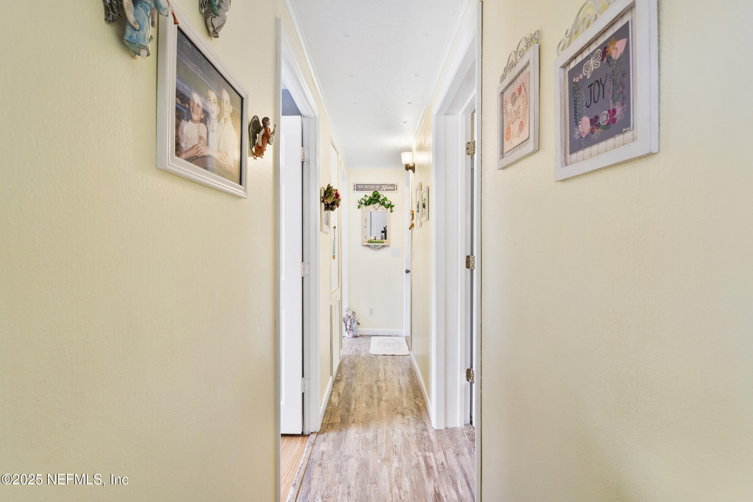 155 Tompkins Road Pomona Park, FL 32181 - Photo 8 of 38 a view of a hallway with wooden floor and closet