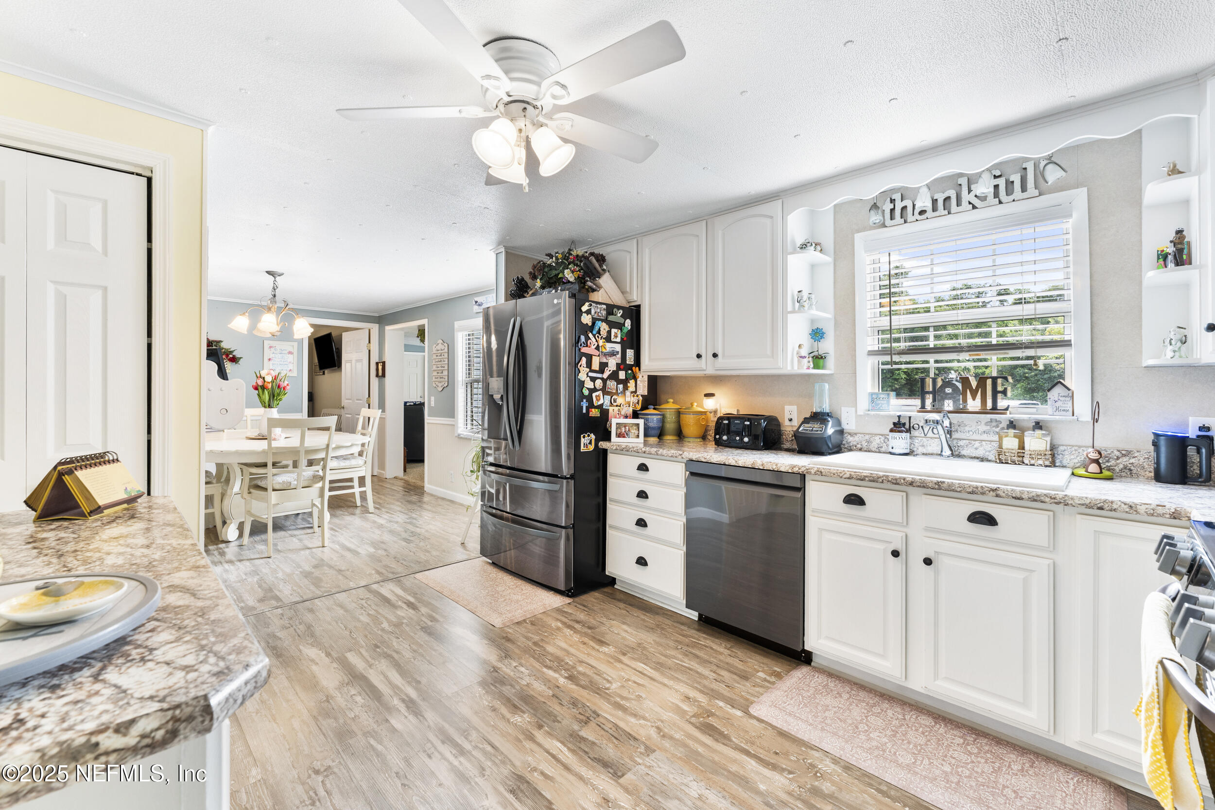 155 Tompkins Road Pomona Park, FL 32181 - Photo 10 of 38 a kitchen with white cabinets and appliances