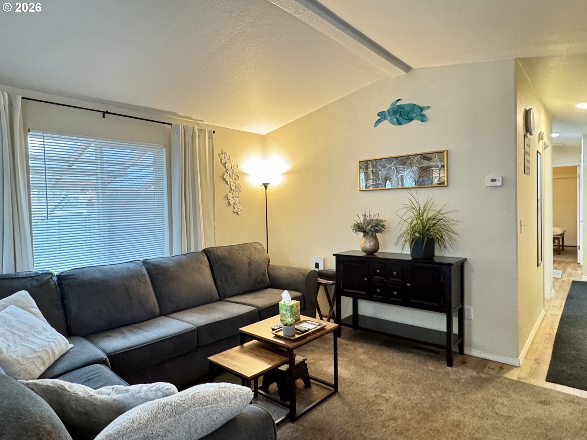 3760 Highway 101, Unit 1 Florence, OR 97439 - Photo 17 of 32 a living room with furniture and a potted plant
