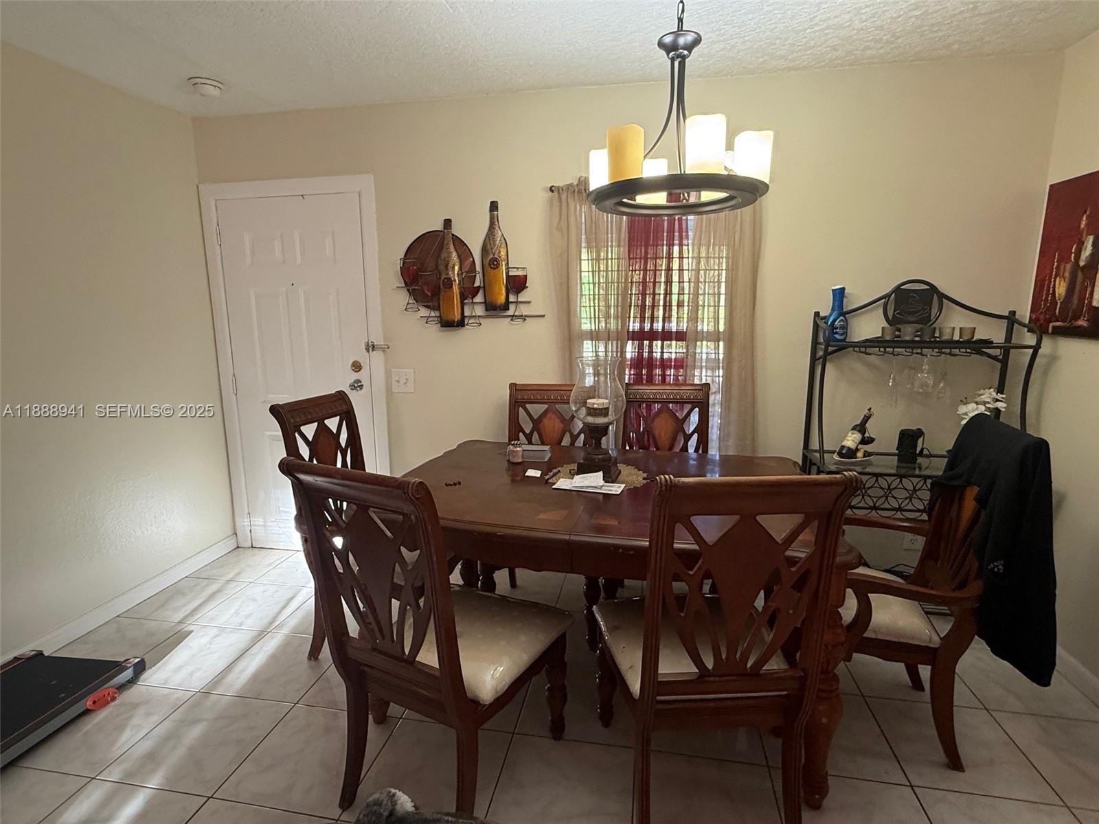 120 South Nogal Street Clewiston, FL 33440 - Photo 2 of 41 a view of a dining room with furniture and chandelier