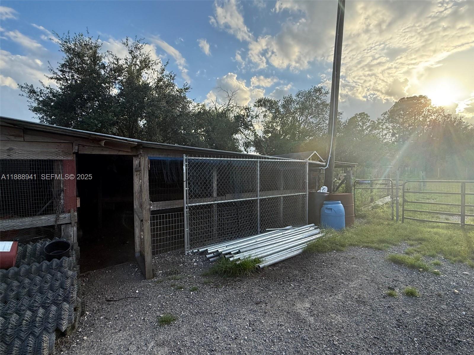 120 South Nogal Street Clewiston, FL 33440 - Photo 25 of 41 a view of a wooden bench in the backyard