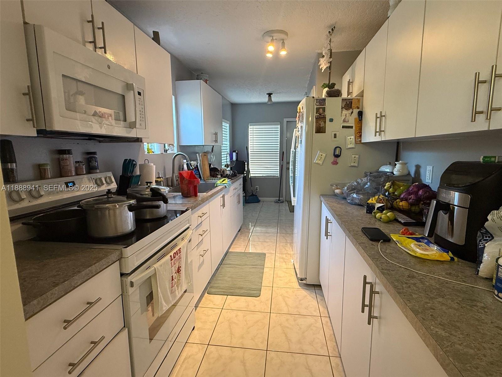 120 South Nogal Street Clewiston, FL 33440 - Photo 4 of 41 a kitchen with stainless steel appliances granite countertop a sink and cabinets
