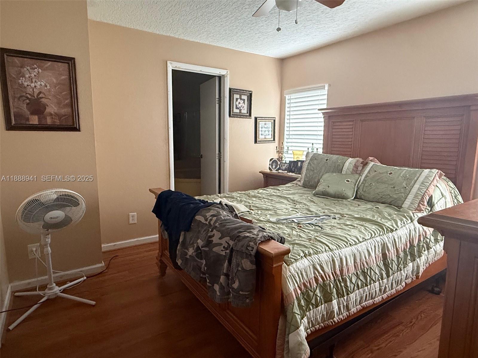 120 South Nogal Street Clewiston, FL 33440 - Photo 6 of 41 a bedroom with a bed and painting on the wall