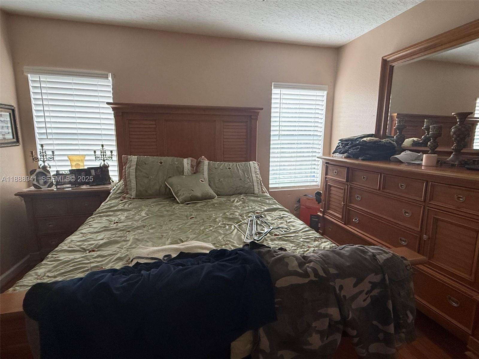 120 South Nogal Street Clewiston, FL 33440 - Photo 7 of 41 a bedroom with a bed and a dresser