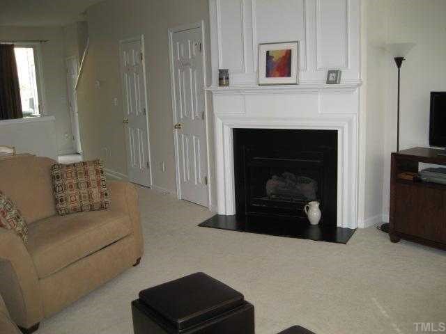 1626 Brook Fern Way Raleigh, NC 27609 - Photo 2 of 8 Notice the Wonderful Wood Trim Surrounding the Gas Fireplace with Gas Logs.