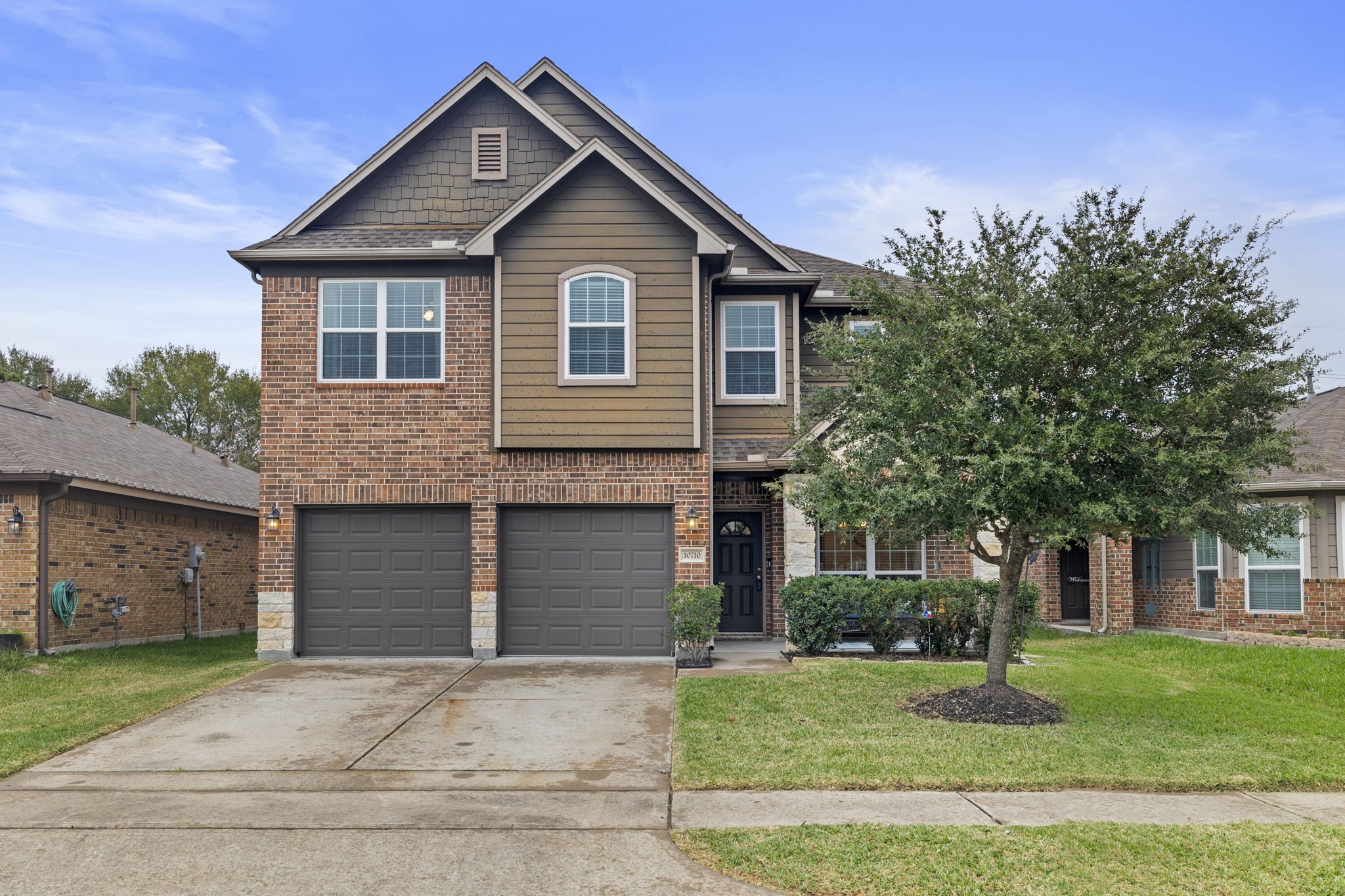 a front view of a house with a yard and garage
