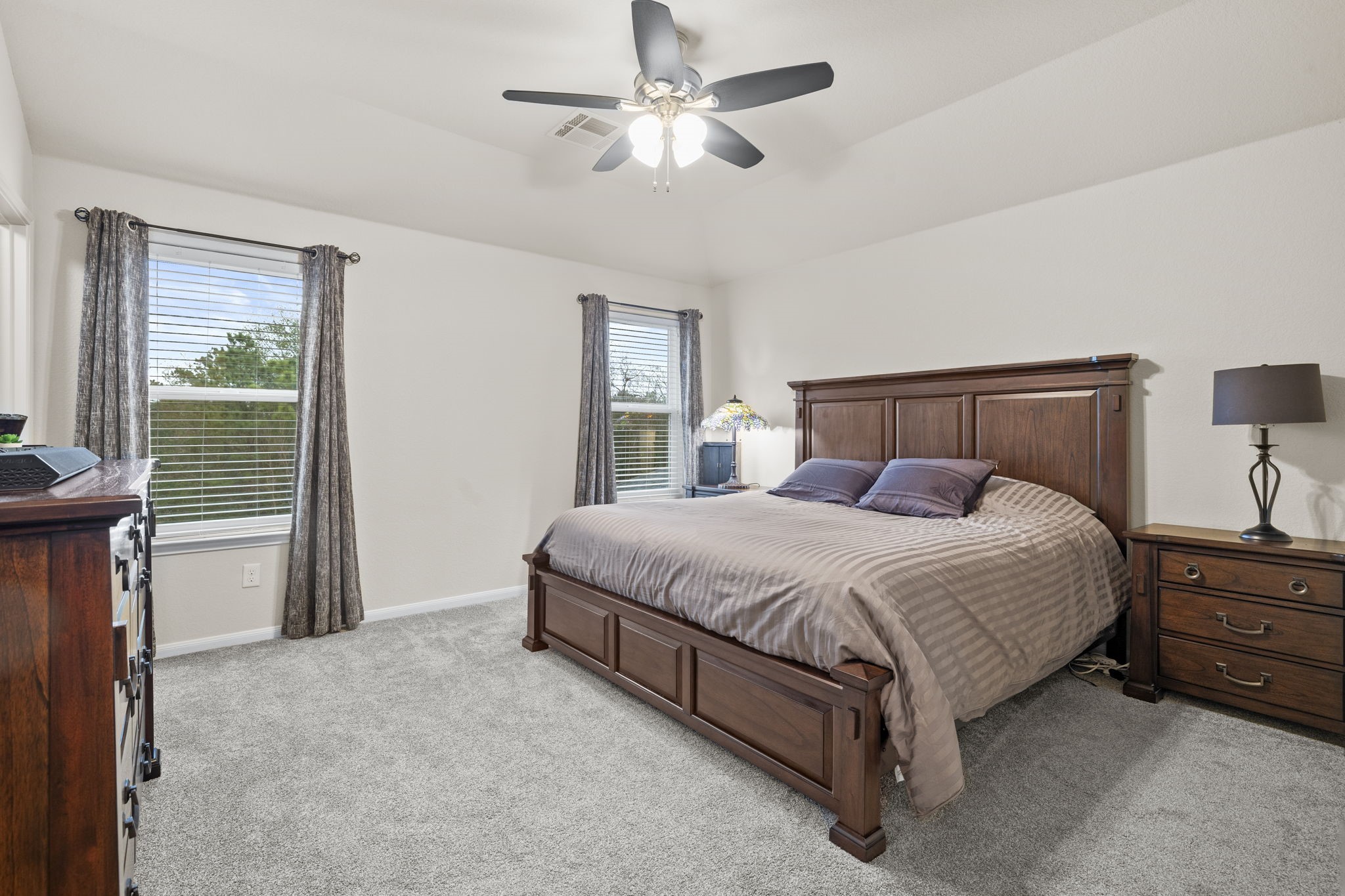 10710 Chestnut Path Way Tomball, TX 77375 - Photo 13 of 26 a bedroom with a bed and a chandelier