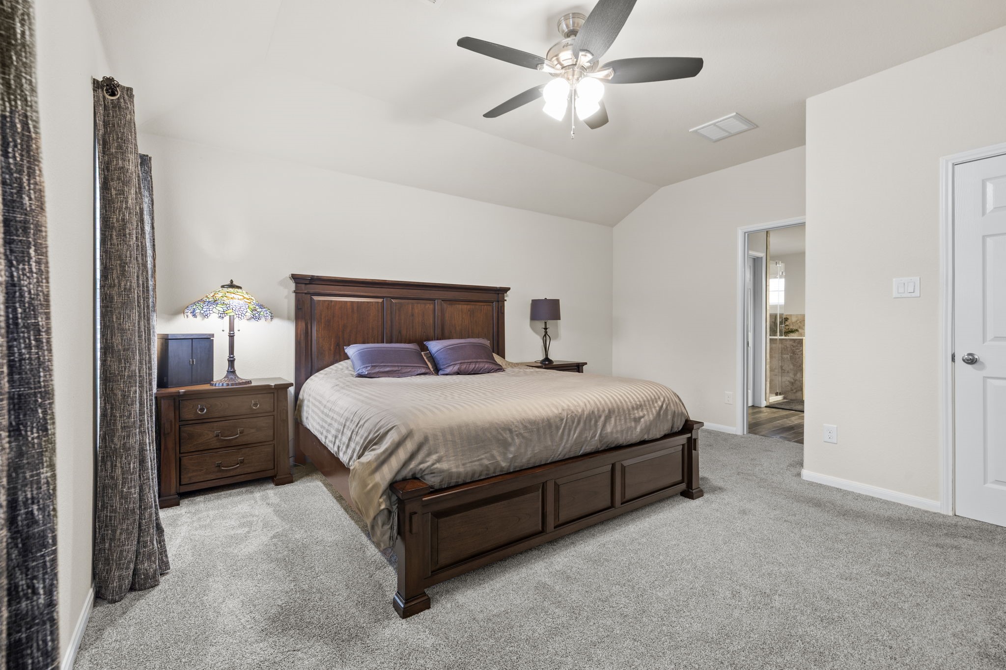 10710 Chestnut Path Way Tomball, TX 77375 - Photo 14 of 26 a bedroom with a large bed and a chandelier
