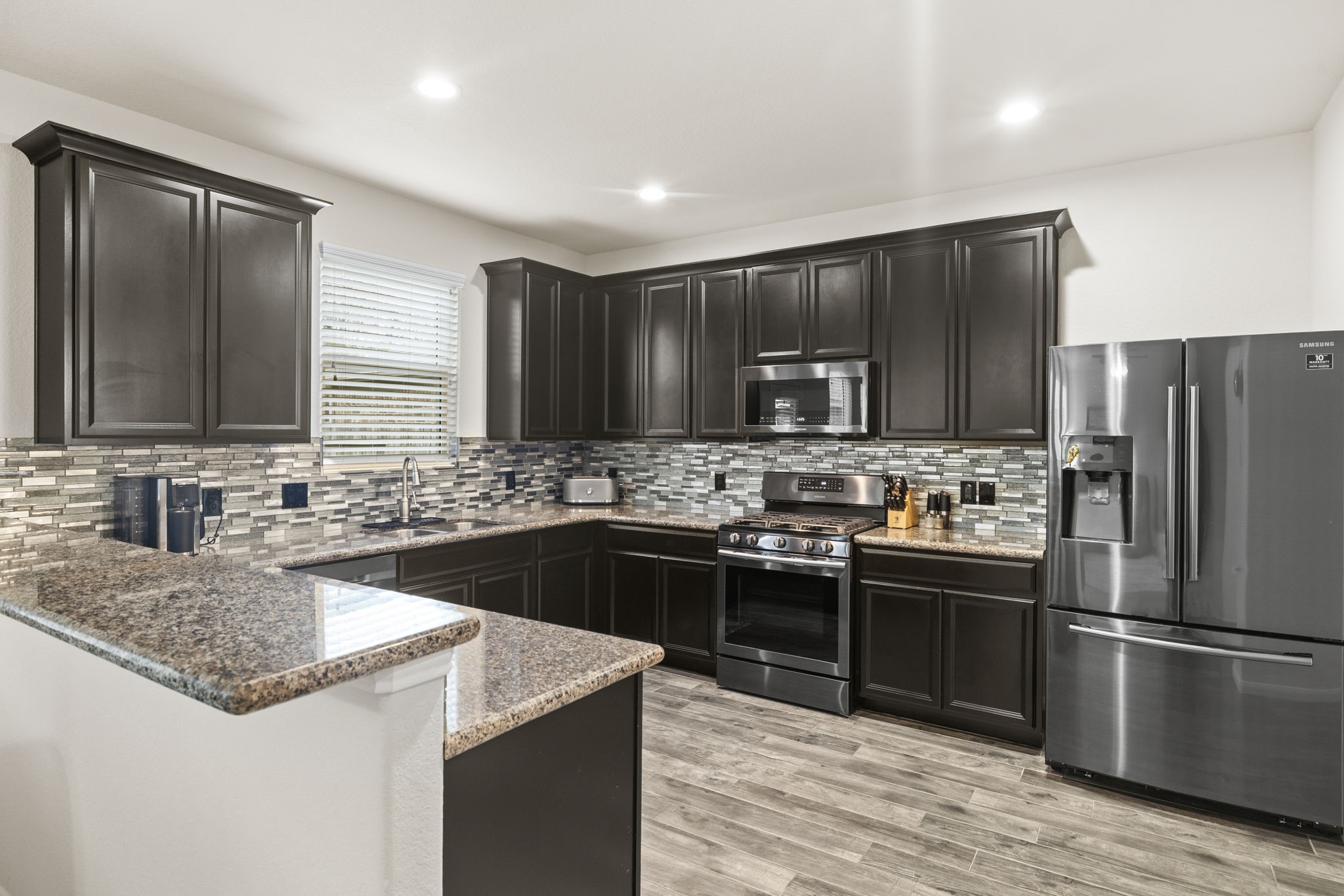 10710 Chestnut Path Way Tomball, TX 77375 - Photo 6 of 26 a kitchen with kitchen island granite countertop a sink stove and refrigerator