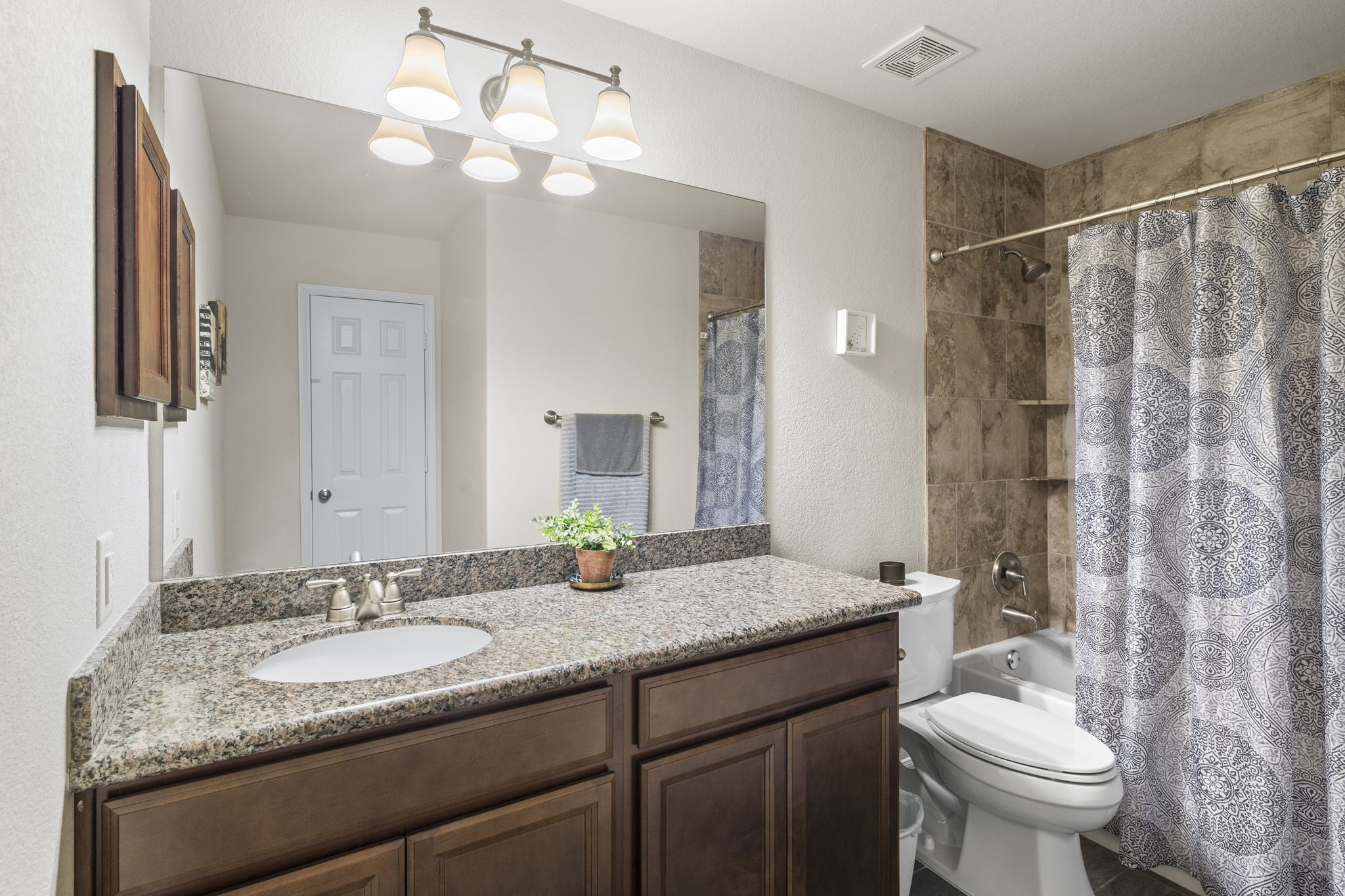 10710 Chestnut Path Way Tomball, TX 77375 - Photo 10 of 26 a bathroom with a granite countertop sink toilet and shower