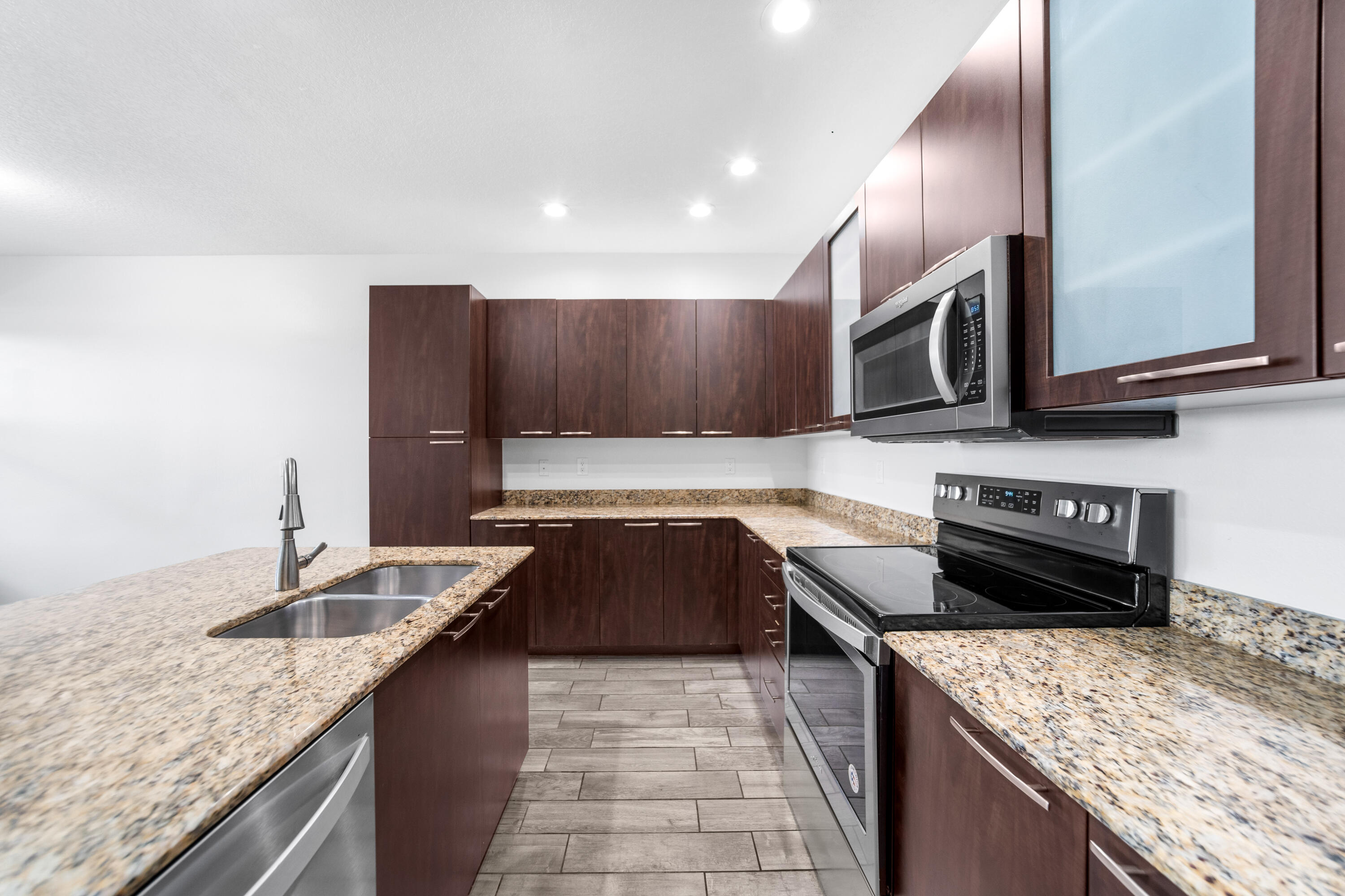 1430 Northwest 48th Lane Boca Raton, FL 33431 - Photo 12 of 54 a kitchen with stainless steel appliances granite countertop a sink stove and microwave