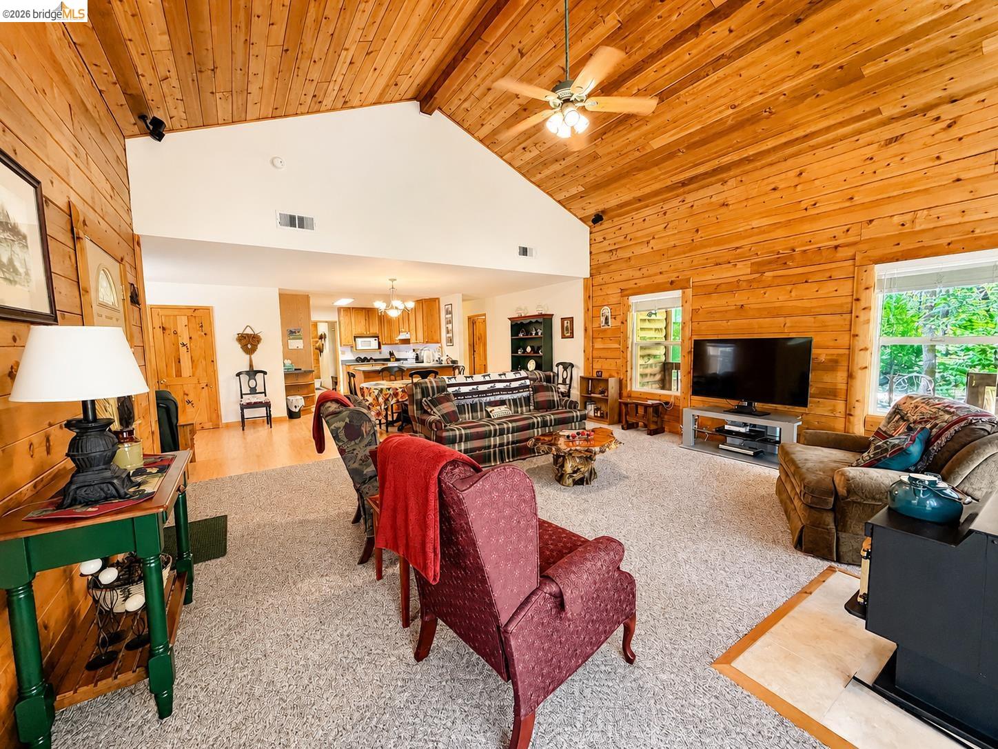 21181 Phoenix Lake Road Sonora, CA 95370 - Photo 10 of 34 Expansive common area featuring vaulted wood-paneled ceilings, wood-finish walls, a ceiling fan, and light-toned carpeting