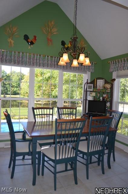 7608 Dewey Road Thompson, OH 44086 - Photo 8 of 25 Eating area of kitchen with vaulted ceiling, walls of windows, ceramic floor and overlooks the scenic views of the pool, pond and woods.